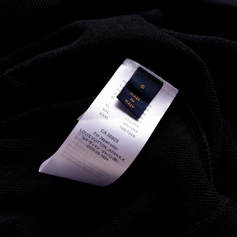 Close-up detail shot of Louis Vuitton luxury clothing with label-forward styling