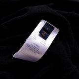 Close-up detail shot of Louis Vuitton luxury clothing with label-forward styling