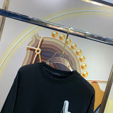 Close-up detail shot of Louis Vuitton luxury clothing with signature branding