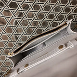 Side profile of chic polished women's handbag – women's statement bag