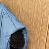 Side profile of Louis Vuitton luxury clothing with logo-detail design
