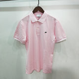 Flat lay presentation of Lacoste luxury clothing with monogram-inspired silhouette