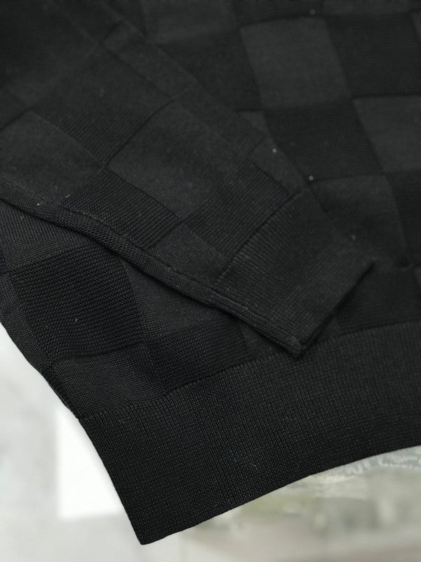 Close-up detail shot of Louis Vuitton luxury clothing with signature branding