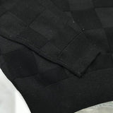 Close-up detail shot of Louis Vuitton luxury clothing with signature branding
