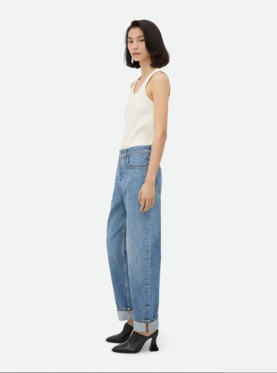 Close-up of Bottega Veneta pants hardware and fine stitching