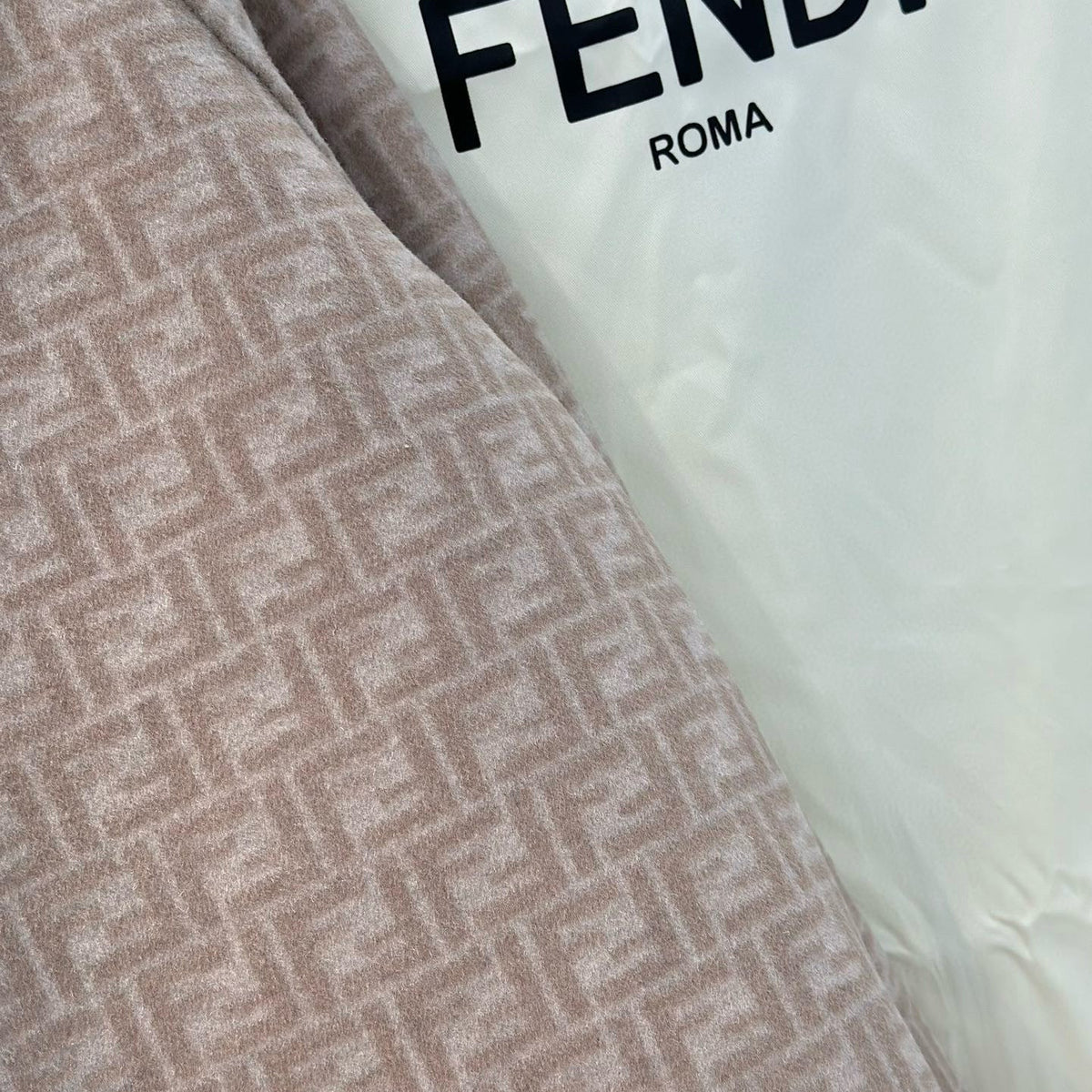 Close-up of Fendi Coat signature hardware and stitching detail