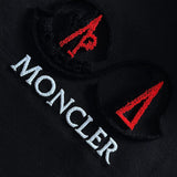 Close-up detail shot of Moncler luxury clothing with signature branding