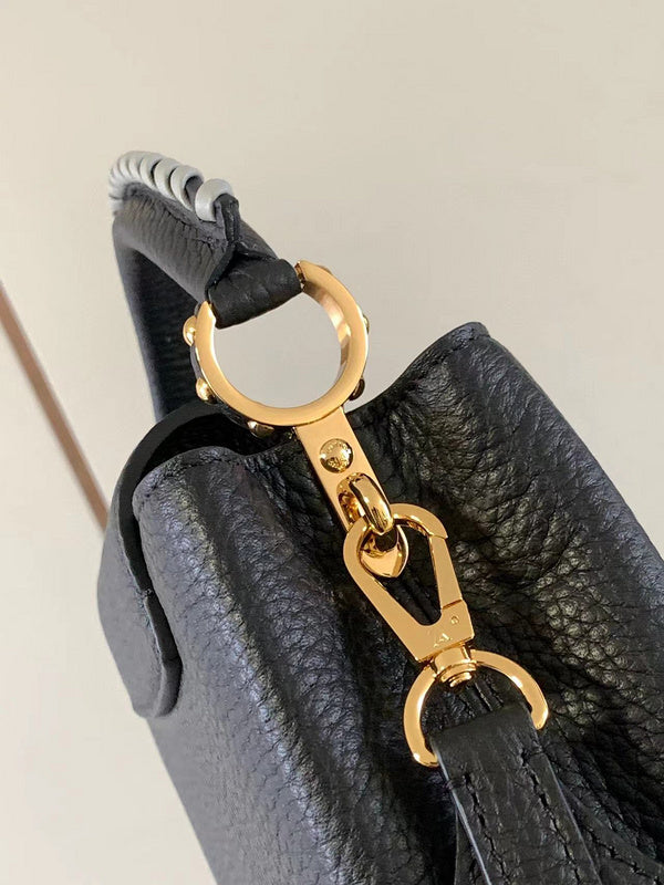 Handle and strap detail of polished structured women's handbag – women's luxury accessory