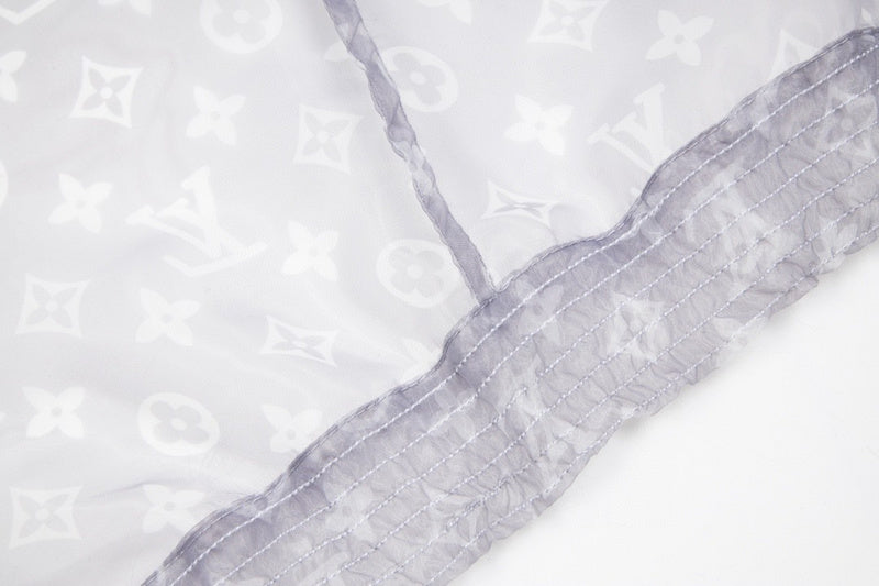 Close-up detail shot of Louis Vuitton luxury clothing with monogram-inspired silhouette