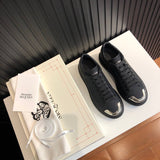 Side profile of Nike tonal black sneakers premium leather build