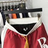 Close-up detail shot of Rhude luxury clothing with label-forward styling