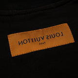Close-up detail shot of Louis Vuitton luxury clothing with signature branding