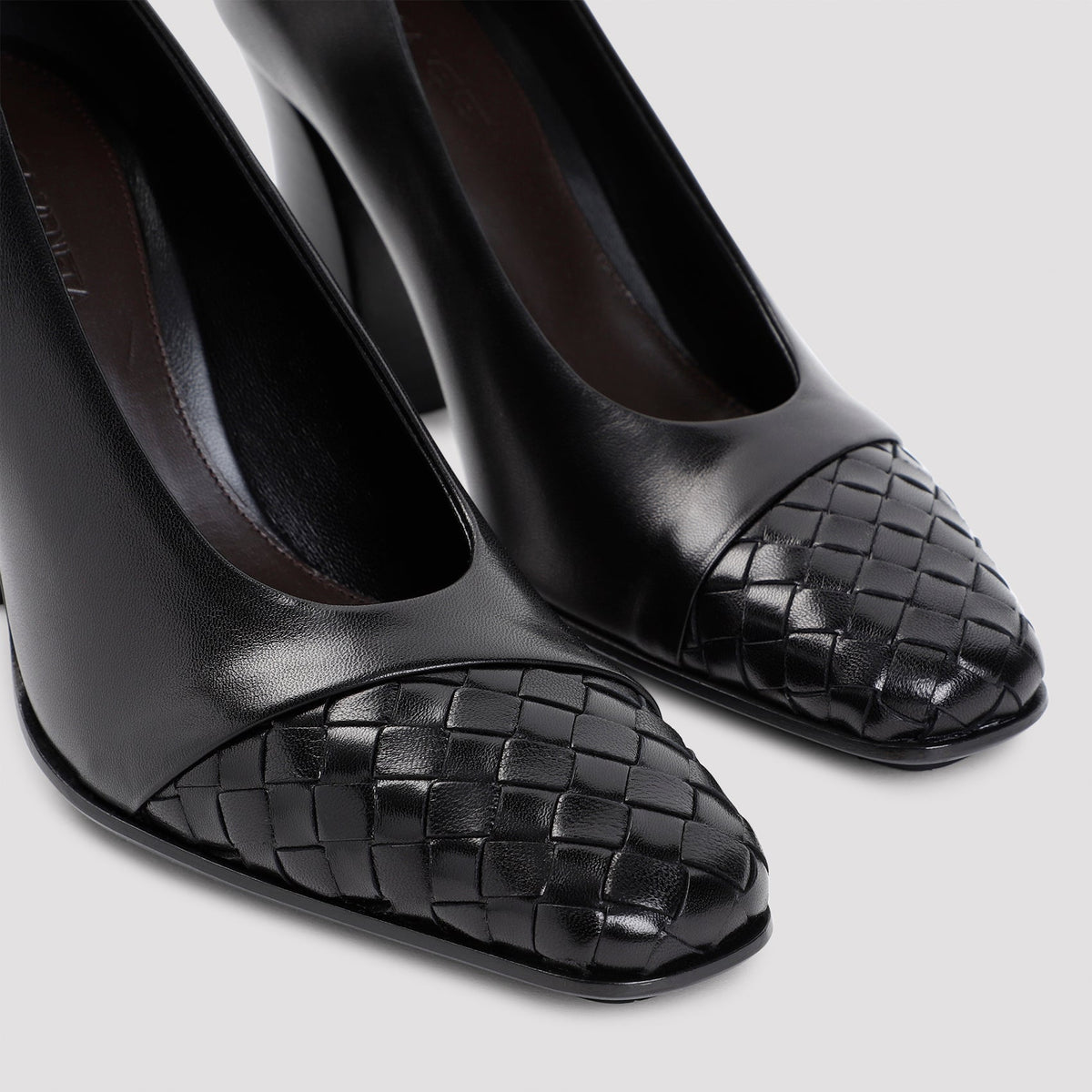Close-up of Bottega Veneta slides hardware and fine stitching