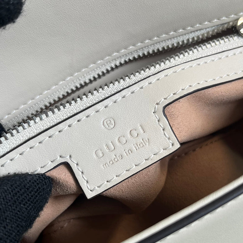 Side profile of structured everyday-luxe women's handbag – women's designer-style accessory