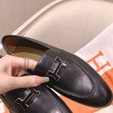 Hermès Grey Bow-Detail Flats - Close-Up Texture View