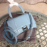 Side profile of structured polished women's handbag – women's designer-style accessory