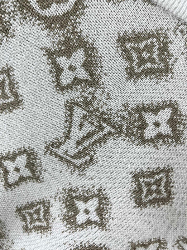 Flat lay presentation of Louis Vuitton luxury clothing with logo-detail design