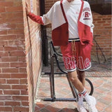 Flat lay presentation of Rhude luxury clothing with monogram-inspired silhouette