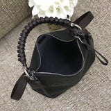 Top view of polished sleek women's handbag – women's luxury accessory
