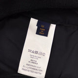 Side profile of Louis Vuitton luxury clothing with signature branding