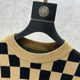 Close-up detail shot of Louis Vuitton luxury clothing with logo-detail design