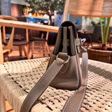Side view of polished structured handbag
