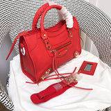 Handle and strap detail of statement polished women's handbag – women's designer-style accessory