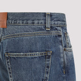 Close-up of Alexander McQueen pants hardware and fine stitching