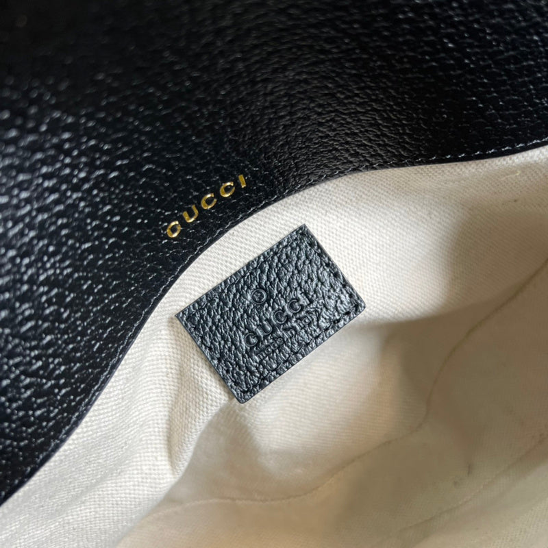 Styled lifestyle shot of structured statement women's handbag – women's statement bag