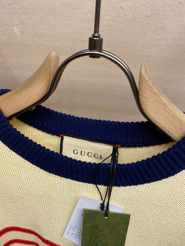 Close-up detail shot of Gucci luxury clothing with label-forward styling
