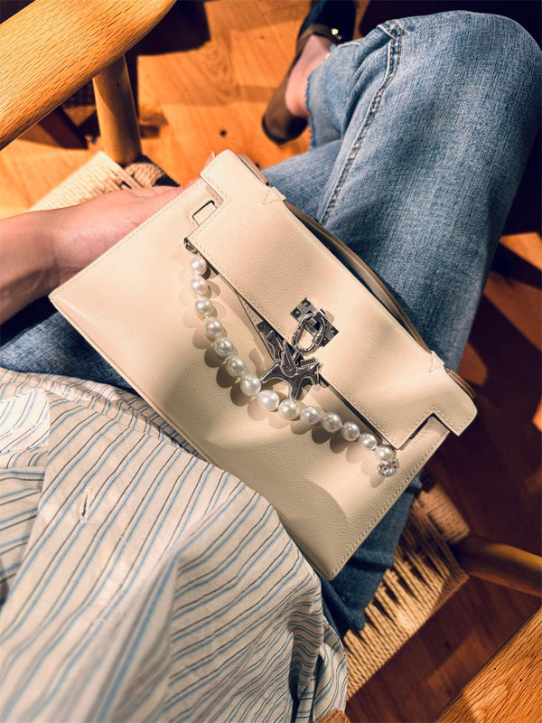  Polished handbag carried on shoulder