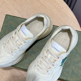 Side profile of Gucci fresh white-and-black sneakers streetwear statement look