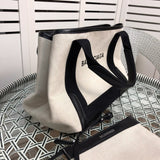Handle and strap detail of modern everyday-luxe women's handbag – women's statement bag