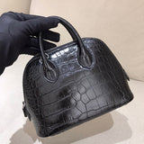 Side view of sleek structured handbag