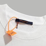 Close-up detail shot of Louis Vuitton luxury clothing with signature branding