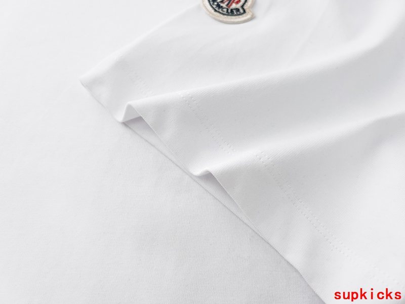Flat lay presentation of Moncler luxury clothing with logo-detail design