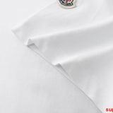 Flat lay presentation of Moncler luxury clothing with logo-detail design