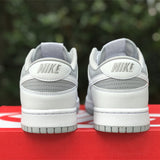 Side profile of Nike two-tone sneakers signature lace-up style