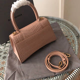 Handle and strap detail of classic structured women's handbag – women's statement bag