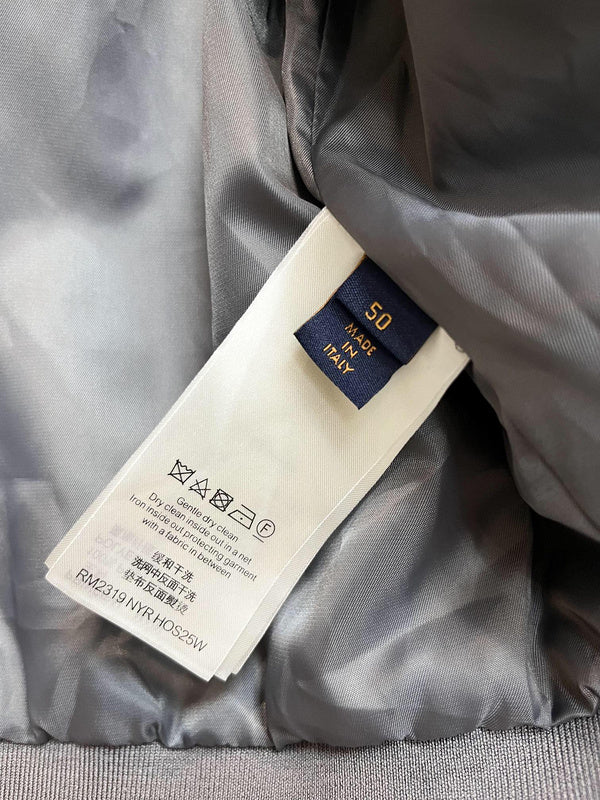 Close-up detail shot of Louis Vuitton luxury clothing with label-forward styling