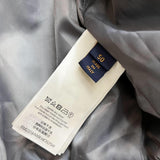 Close-up detail shot of Louis Vuitton luxury clothing with label-forward styling