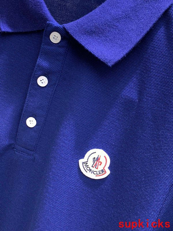 Flat lay presentation of Moncler luxury clothing with signature branding
