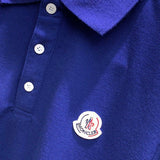 Flat lay presentation of Moncler luxury clothing with signature branding