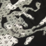 Close-up detail shot of Louis Vuitton luxury clothing with logo-detail design