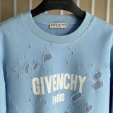 Close-up detail shot of Givenchy luxury clothing with logo-detail design
