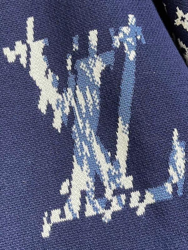 Close-up detail shot of Louis Vuitton luxury clothing with monogram-inspired silhouette