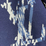 Close-up detail shot of Louis Vuitton luxury clothing with monogram-inspired silhouette