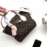 Side profile of statement refined women's handbag – women's everyday handbag