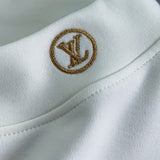 Flat lay presentation of Louis Vuitton luxury clothing with everyday silhouette