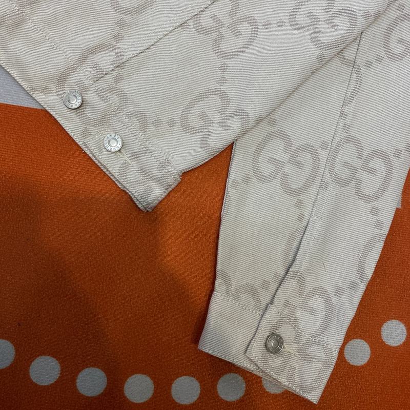 Side profile of Gucci luxury clothing with logo-detail design